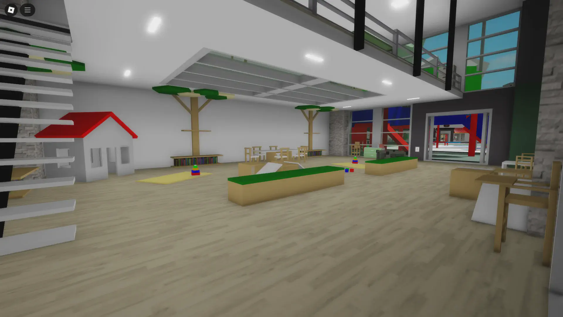 The first floor of the remodeled daycare in BrookhavenRP's remodel update, featuring a playhouse, wooden play structures, bookshelves, and an open play space.