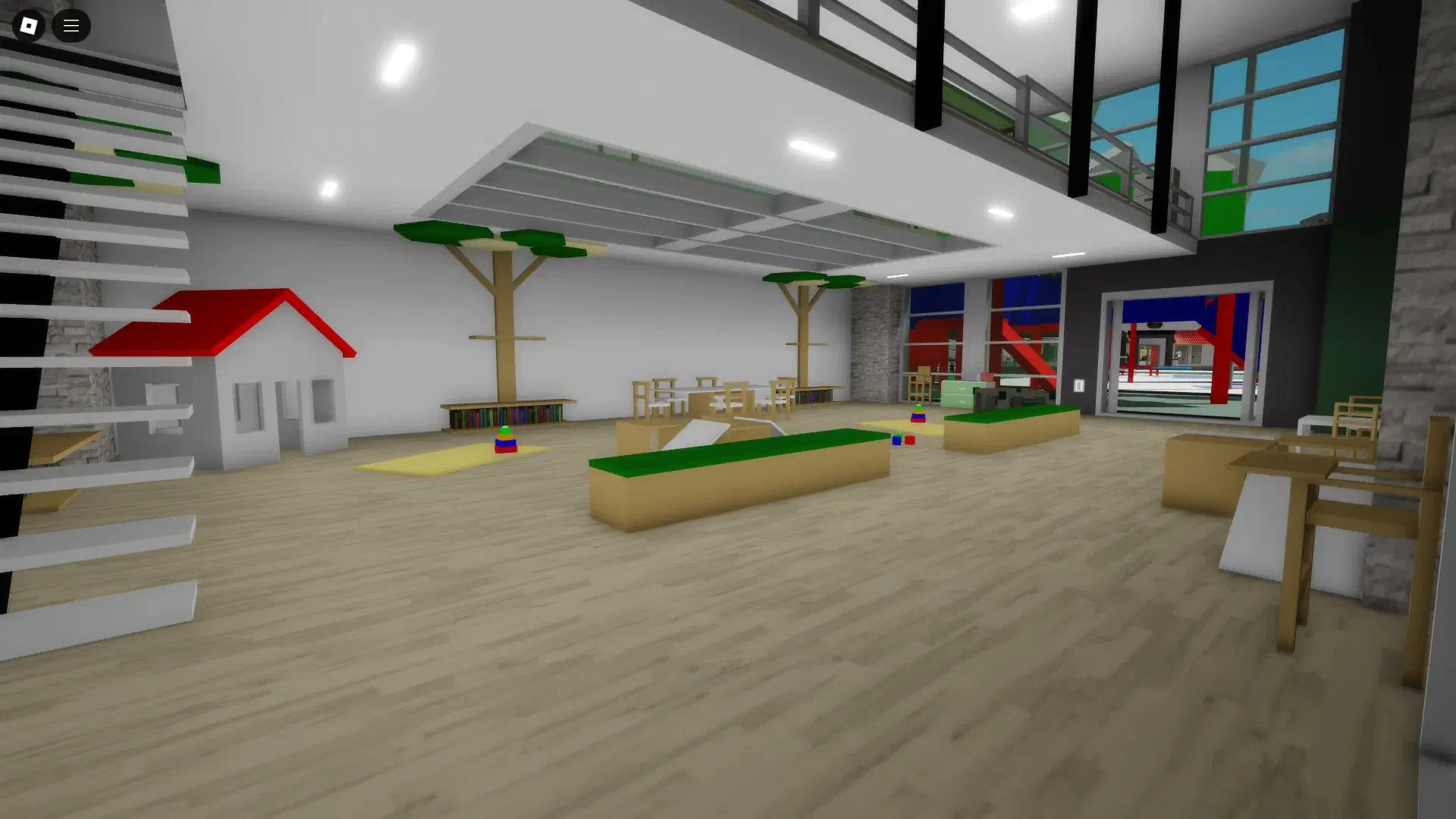 The first floor of the remodeled daycare in BrookhavenRP's remodel update, featuring a playhouse, wooden play structures, bookshelves, and an open play space.
