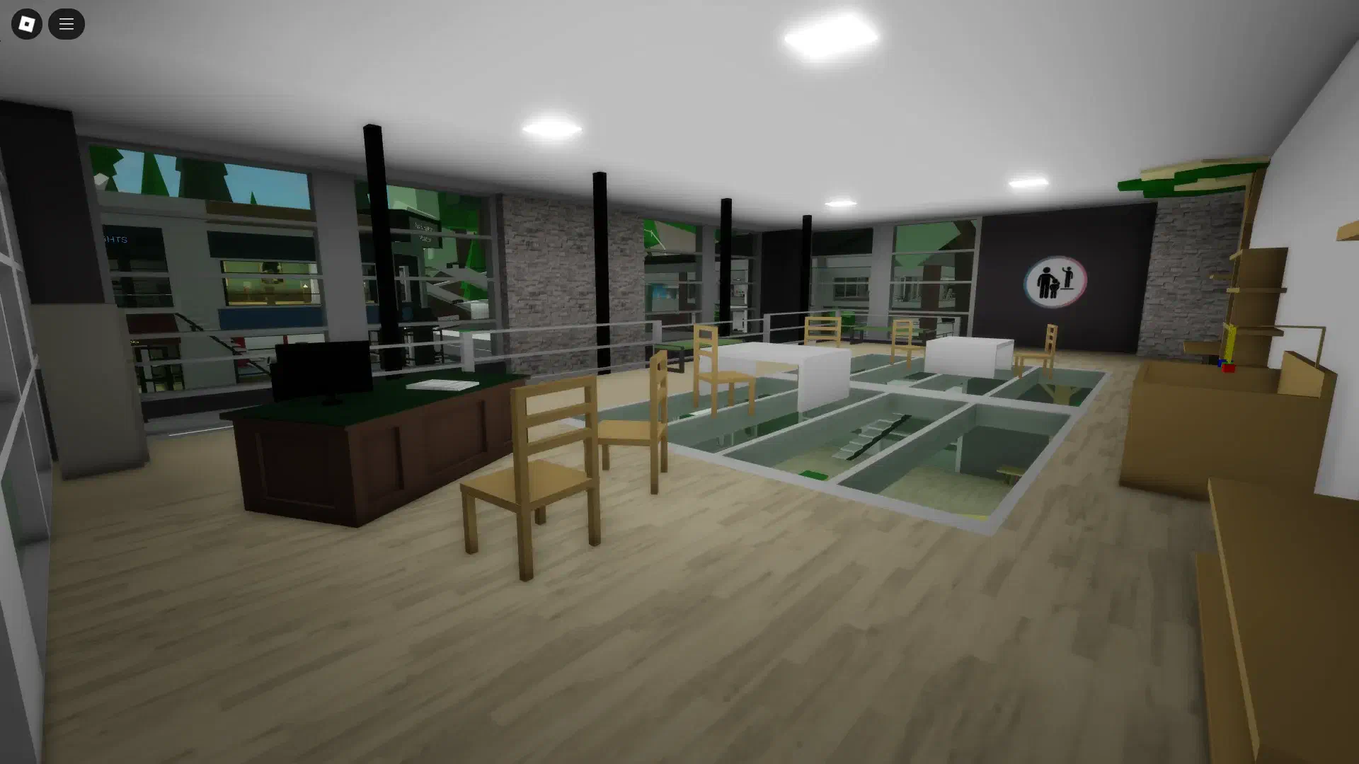 The second floor of the daycare in BrookhavenRP's remodel update, now designed as an adoption center with a desk, seating area, and glass flooring looking down into the play area.